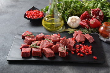 Diced raw beef with ingredients, herbs, spices and pomegranate