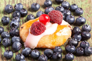 Homemade oatmeal cookies with blueberry for a healthy vegetarian breakfast on a green wooden background, close-up, horizontal