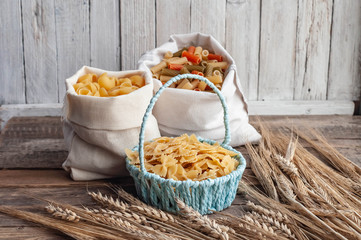 pasta with wheat spikelets on a wooden table