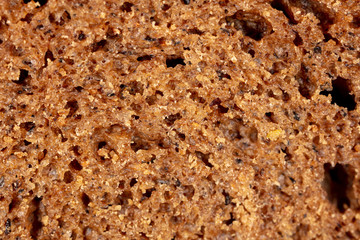 Black rye bread as an abstract background