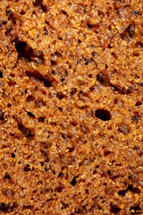 Black rye bread as an abstract background