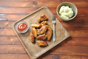 Grilled, barbecue chicken wings, tasty food for dinner or lunch. Fried chicken wings with sesame seeds. Fast food concept