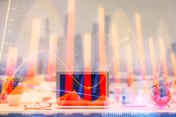 Forex graph hologram on table with computer background. Multi exposure. Concept of financial markets.