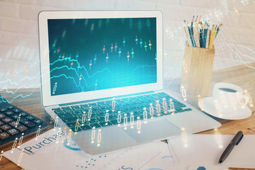 Stock market graph and table with computer background. Double exposure. Concept of financial analysis.