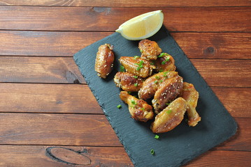 Grilled, barbecue chicken wings, tasty food for dinner or lunch. Fried chicken wings with sesame seeds. Fast food concept