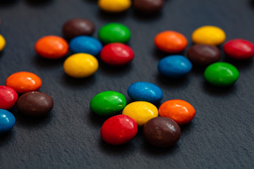 colorful chocolate buttons isolated on a black background