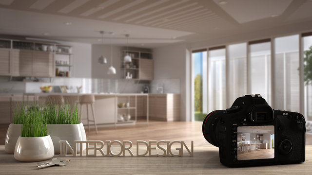 Architect photographer designer desktop concept, camera on wooden work desk with screen showing interior design project, blurred scene in the background, modern kitchen idea template