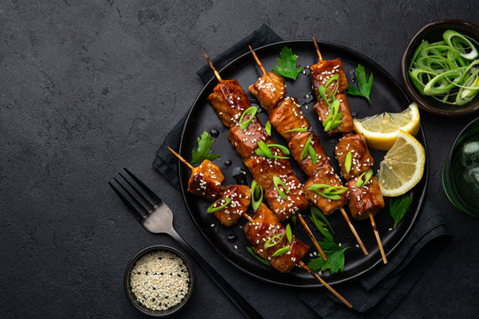 Teriyaki Salmon Skewers On Black Plate