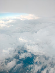 Sunrise above clouds from airplane window. Bright blue sky top horizontal view copyspace. Travelling concept View of the engine.