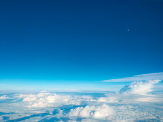 Sunrise above clouds from airplane window. Bright blue sky top horizontal view copyspace. Travelling concept View of the engine.