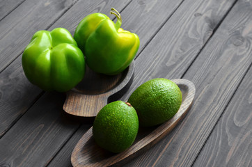 Fresh green vegetables. Pure selection and source of vegetable protein on a wooden rustic background. Avocados and green peppers.
