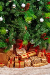 Stack of wrapped presents under Christmas tree