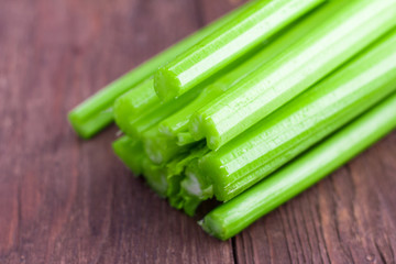 fresh organic celery on wooden background, close-up