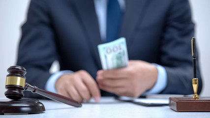 Corrupt lawyer holding bribe money in hands, falsified business agreement, crime
