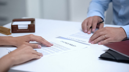 Ex spouses signing divorce policy in attorney office, legal end of relations