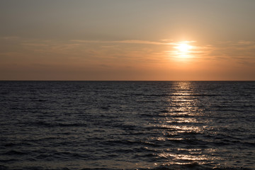 Fototapeta premium Dark sea surface with waves and sun reflection