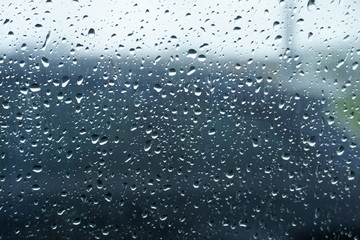 Raindrops on a car glass. Rainy autumn day, foggy windows and wet windows.