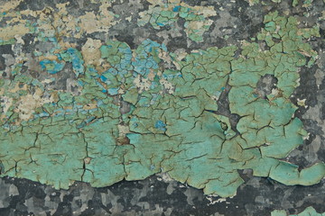 Background. A fragment of the iron surface is covered with old turquoise paint that has long been on it