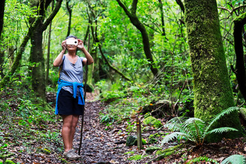 brave woman trekking walking in Madeira island levadas and routes