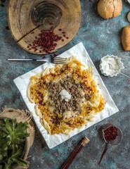 azerbaijani khangal thinly cutted dough topped with minced meat and caramelized onion