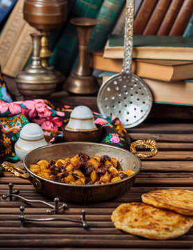 azerbaijani jiz-biz cooked with lamb spleen and potato in copper pan