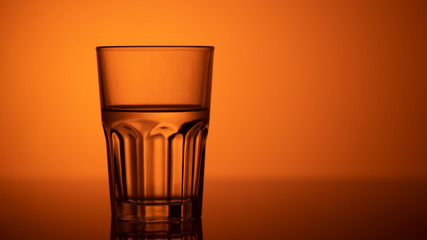 glass of water on color background