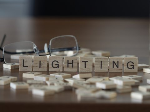 The concept of Lighting represented by wooden letter tiles