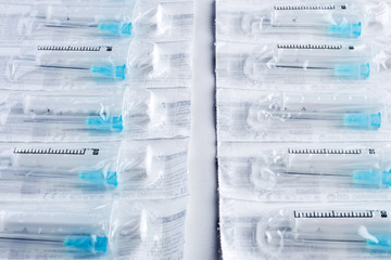 Syringes with covered needles isolated on white background