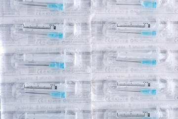 Syringes with covered needles isolated on white background