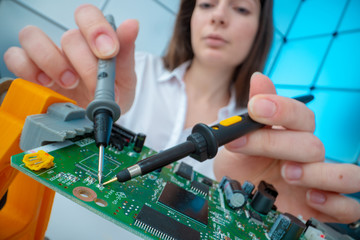 Girl with measuring devices in the electronics laboratory