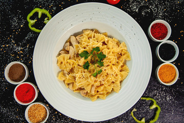 farfalle with chicken and mushroom garnished with grated parmesan