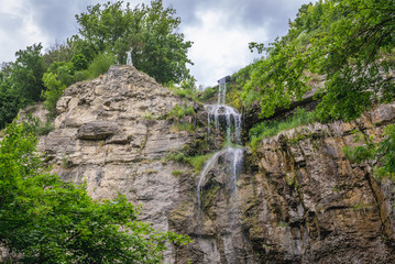 Rock wall and waterfall seen from Smotrych River canyon in Kamianets Podilskyi, Ukraine