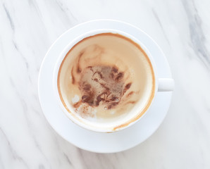 Top view of empty cup of coffee on white marble.