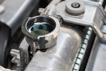Antifreeze in the radiator. Closeup detail of a Flat-four (boxer) car engine compartment under the open hood