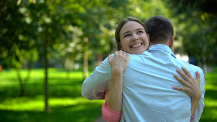 Smiling woman hugging man, long-awaited meeting, warm friendly relationship