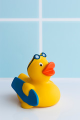 Yellow rubber duck with surfboard