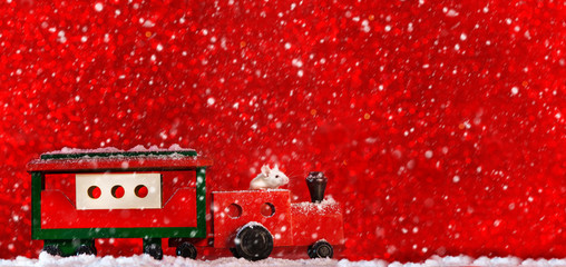 Vintage wooden train, locomotive with a rat mouse on a red background.Creative concept  for new yaer.Copy  space