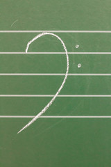 Musical blank staves on a blackboard with bass clef