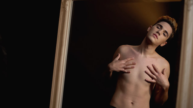 Male transgender touching body sensually, dreaming of breast augmentation - Powered by Adobe