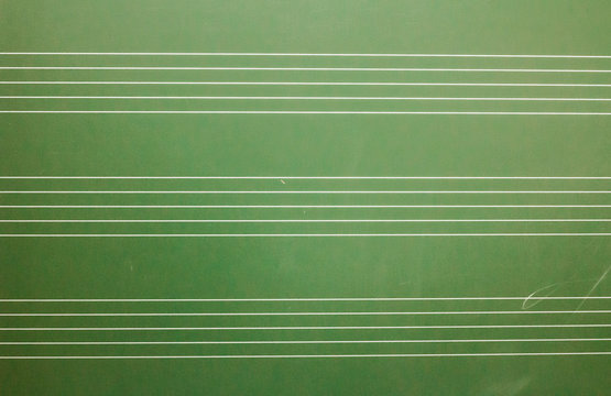 Musical blank staves on a blackboard