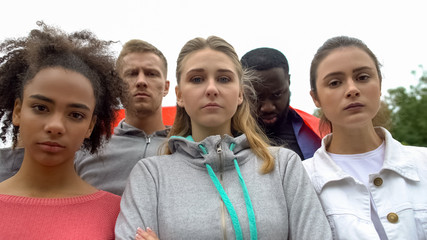 Group of volunteers angrily looking at camera, protest against harassment