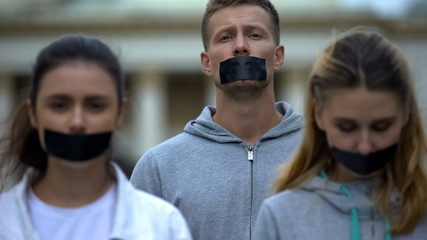 Journalists having taped mouth, violation of speech freedom, corruption bribery