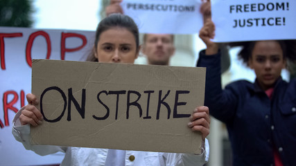 People waving banners on strike, protection of employee rights, work conditions