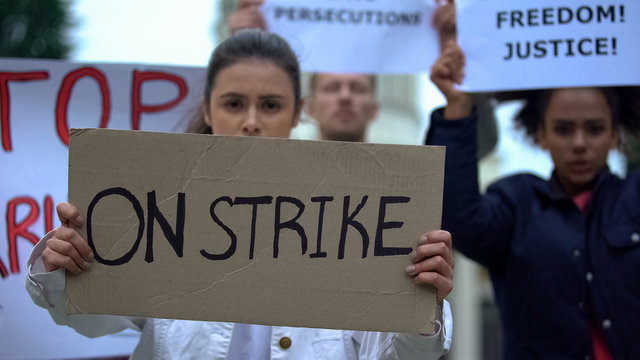 People waving banners on strike, protection of employee rights, work conditions