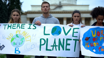 Ecologists holding posters to protect earth from plastic waste pollution problem