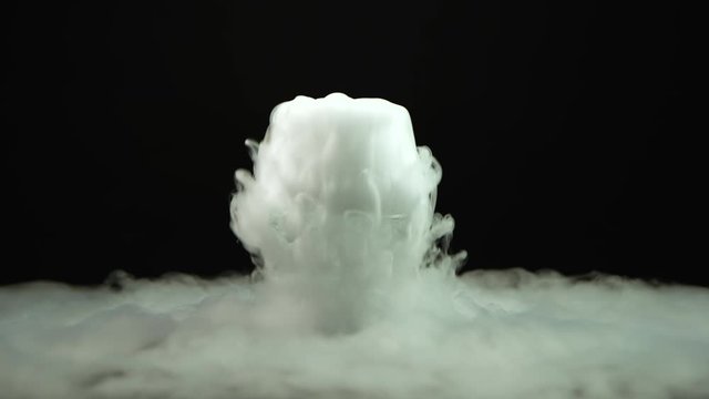 Cognac glass with the effect of white dry ice at black background