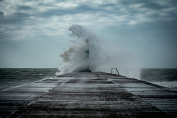 Strong winds create big waves that batter into Aberystwyth, Mid Wales sea front during the Storm season.