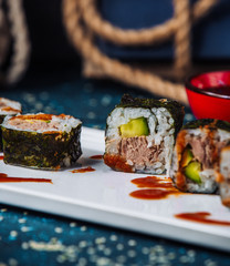 close up of nori sushi rolls with tuna and cucumber