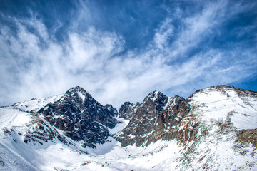 Fototapeta na wymiar Snowy Lomnicky peak on a sunny day with a blue sky