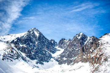 Snowy Lomnicky peak on a sunny day with a blue sky